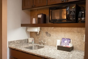 A kitchen with granite countertops, a stainless steel sink, a microwave, and a coffee machine. - Orlando | Simple Safari Escape | Pool + Wildlife (Bay Lake)
