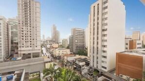 A high-rise residential building with multiple floors, a central courtyard, and a street view. - Complete Studio in Perdizes Cep00428 (São Paulo)