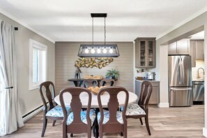 A dining area with a round table, six chairs, and a pendant light fixture. - The Only True Ski-in/ski-out Resort @ Sugar Mtn (Sugar Mountain)