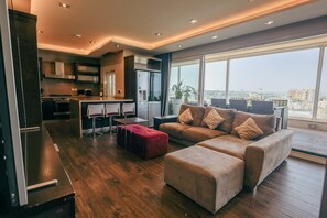 A modern living space with a kitchen, dining area, and seating area with a view. - Luxury Duplex With Jacuzzi, Stunning Views (St. Julian's)