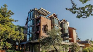 A multi-story building with a modern architectural design, featuring large windows and a mix of materials. - Exclusivity in the Heart of Gramado! Dms0203 (Gramado)