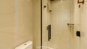 A modern bathroom with a glass-enclosed shower, a toilet, and a sink. - Exclusivity in the Heart of Gramado! Dms0203 (Gramado)