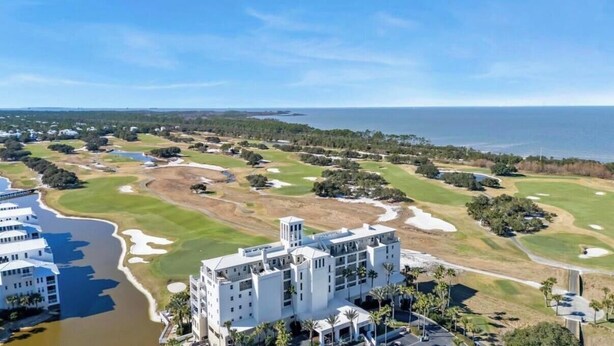 A coastal golf course with a large building adjacent to the water. - Beachfront Getaway w/ Pools, Sauna & Ocean Views (Gulf Shores)