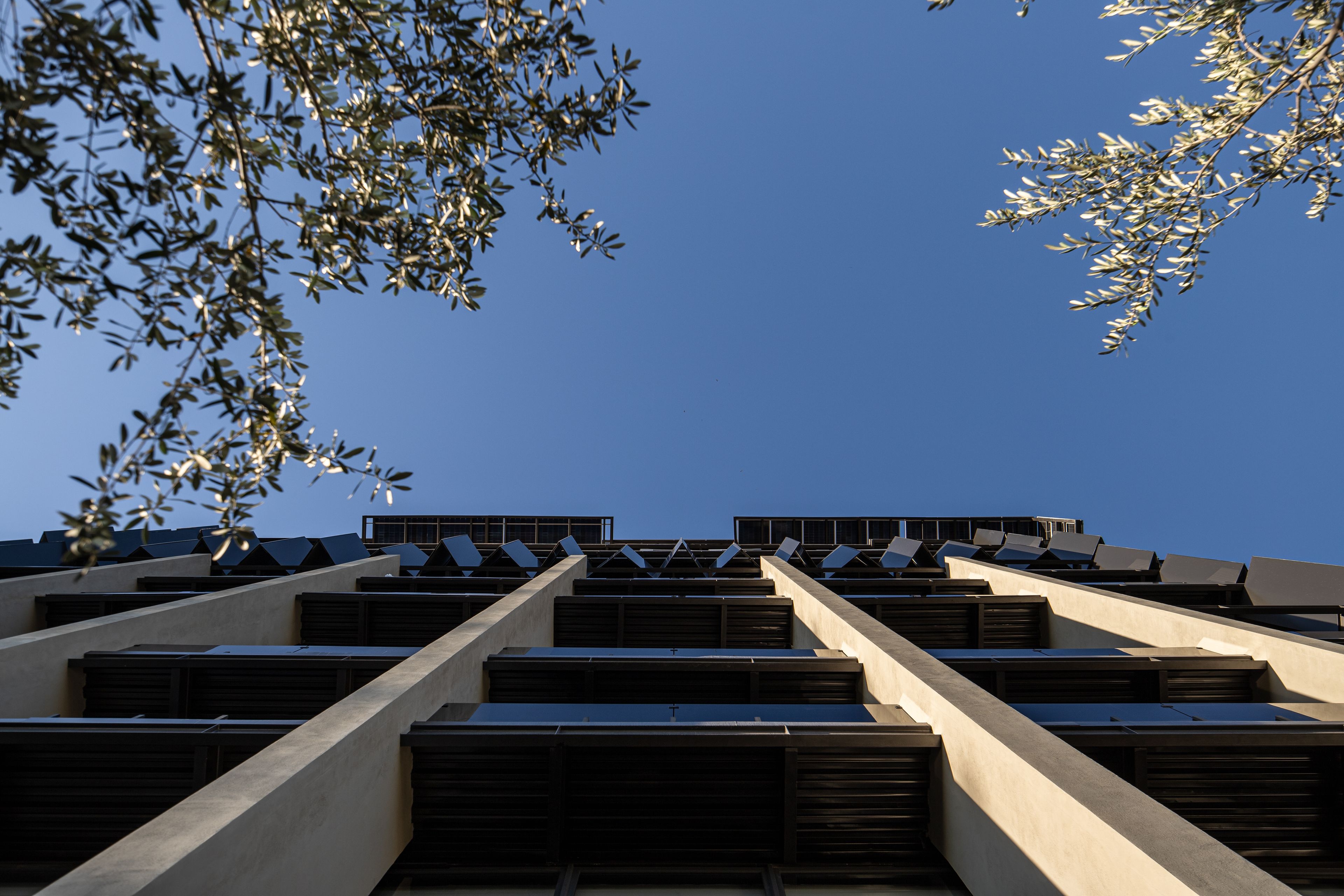 A modern building with a geometric facade and a series of horizontal windows.