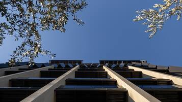 A modern building with a geometric facade and a series of horizontal windows.