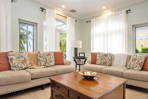A living room with two sofas, a coffee table, and a lamp. - Paradise Villa - 3BR / 3BA w/ Boat Slip in February Point (George Town)