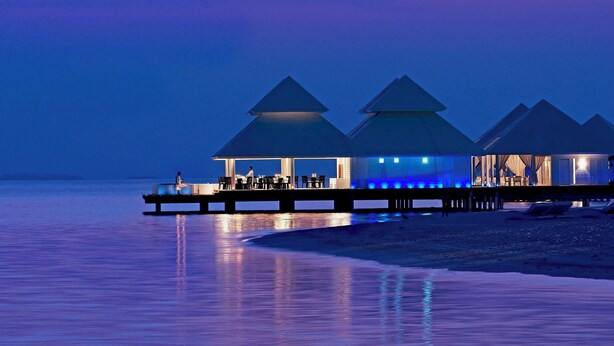 A waterfront resort with overwater bungalows and a pier. - Diamonds Athuruga Maldives Resort and SPA (Athuruga Island)