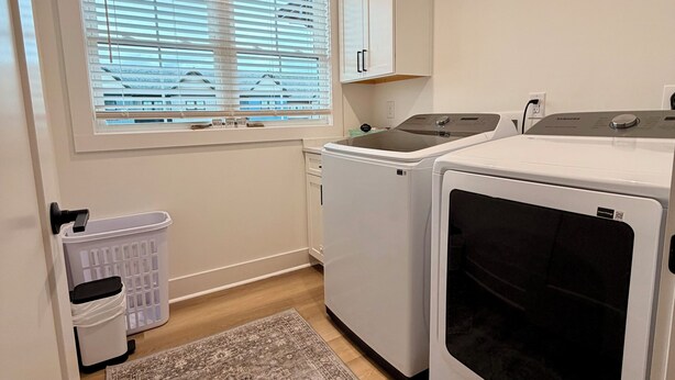 A laundry room with a washing machine, dryer, and a radiator. - Refuge at Augusta 12 Min to LU  Quiet Community with private Screened Porch (Rustburg)