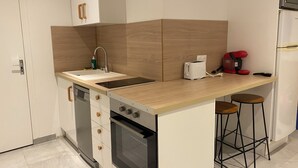 A compact kitchen with a sink, a toaster, a coffee maker, and a refrigerator. - Apartment in Downtown Chalamont (Chalamont)