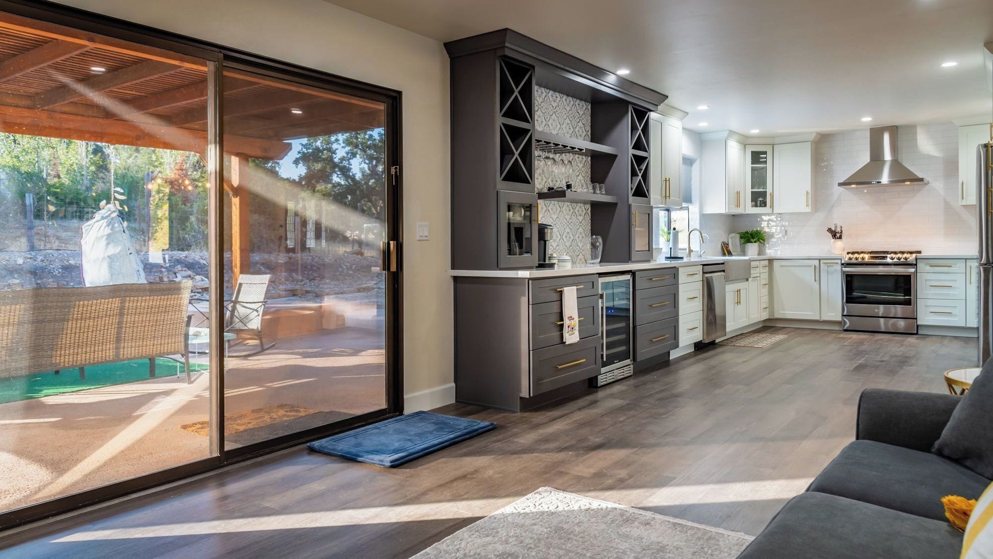 A modern kitchen with a sliding glass door leading to a patio area.