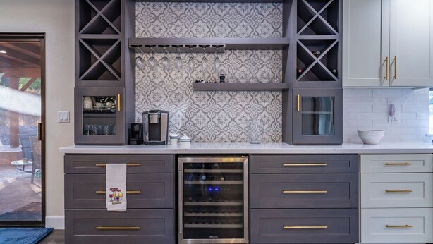 A modern kitchen with a built-in wine cooler, a coffee maker, and a glass-fronted cabinet. - Na Hoku Ranch by Avantstay Spanish Hacienda + Spa + Court 5.5 Acres Near Paso (Atascadero)