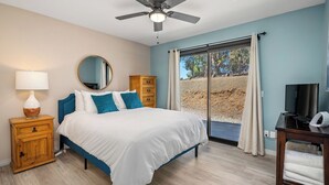 A bedroom with a bed, a nightstand, a dresser, a ceiling fan, a television, and a sliding glass door leading to an outdoor area. - Casa Merlot by Avantstay Pool Table + Firepit + BBQ Eastside Paso Wine Country (Paso Robles)