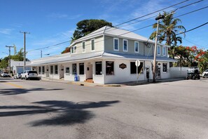 A two-story building with a covered porch and a sign indicating it is a chiropractic clinic. - Old Town Apartment with Parking, Walk to the Beach (Key West)