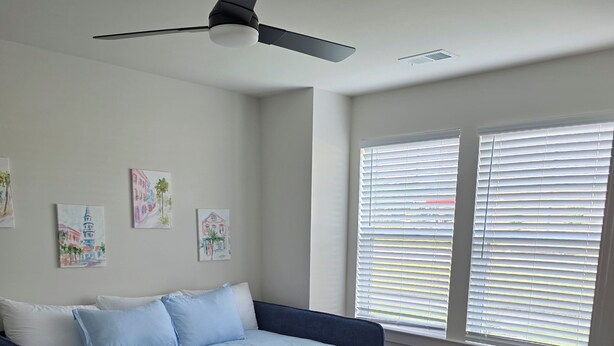 A bedroom with a bed, a desk, and a ceiling fan. - Bright & Cozy 3BR Near Historic Summerville (Summerville)