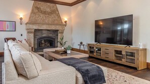 A living room with a fireplace, a sofa, a coffee table, and a TV. - Mira Vista Vineyard Estate by Avantstay Infinity Pool 82-acre Estate (Paso Robles)