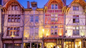 A row of traditional half-timbered buildings with storefronts, including 'San Marina' and 'Burton of London'. - Holiday Inn Express Troyes Gare By Ihg (Troyes)