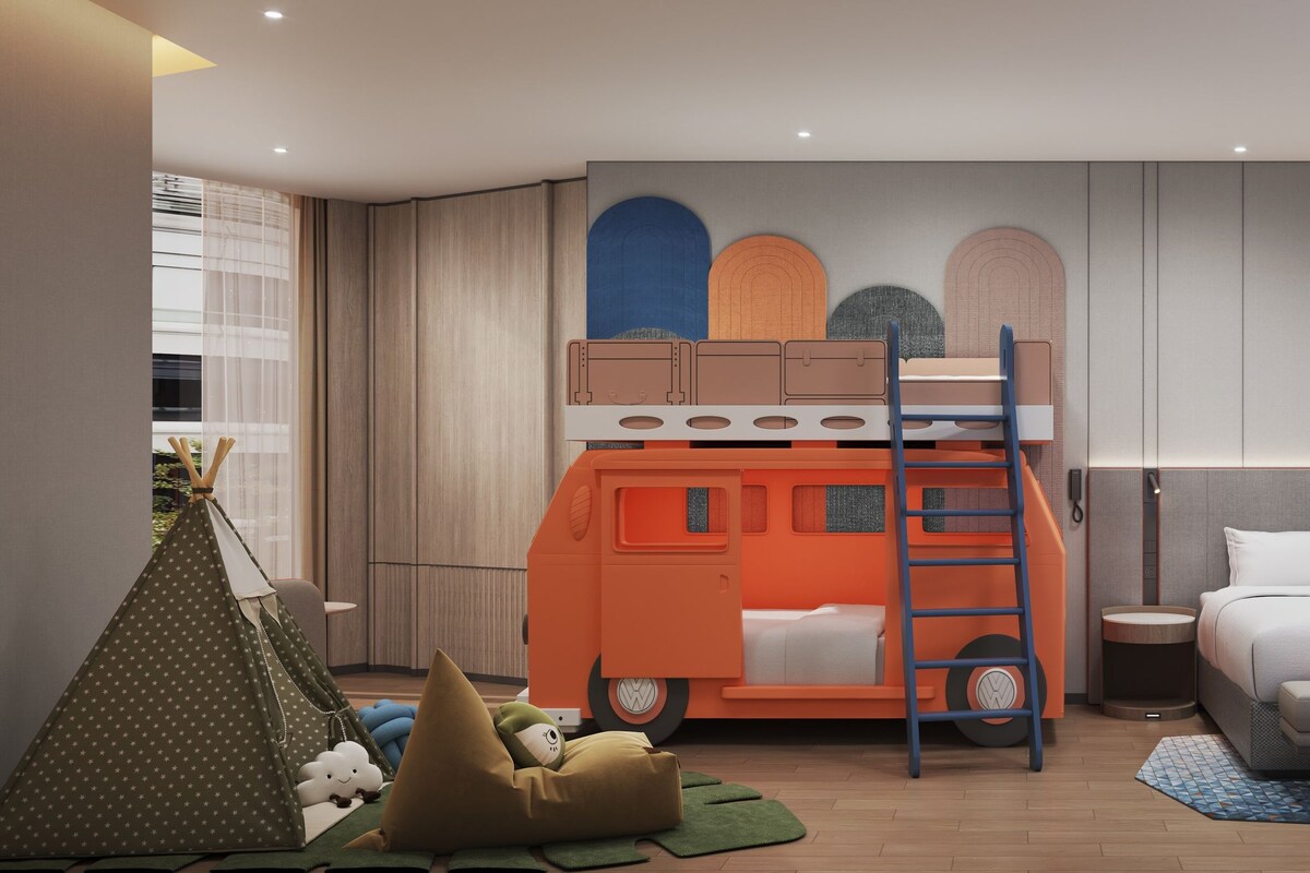 A modern bedroom with a bunk bed, a single bed, a tent, and a wall with decorative elements.
