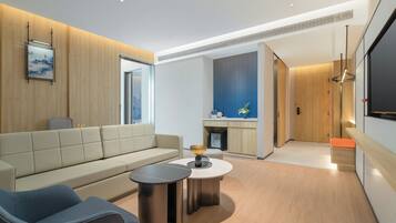 A modern living room with a sofa, a coffee table, and a seating area.