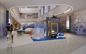 A modern hotel lobby with a central seating area, a decorative panda statue, and a Holiday Inn Express sign. - Holiday Inn Express Dujiangyan Ctc By Ihg (Chengdu)