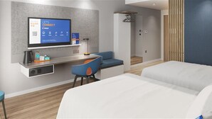 Ein modernes Hotelzimmer mit einem Bett, einem Schreibtisch, einem Sessel und einem Fernseher, der die Aufschrift 'Let's Connect' zeigt.