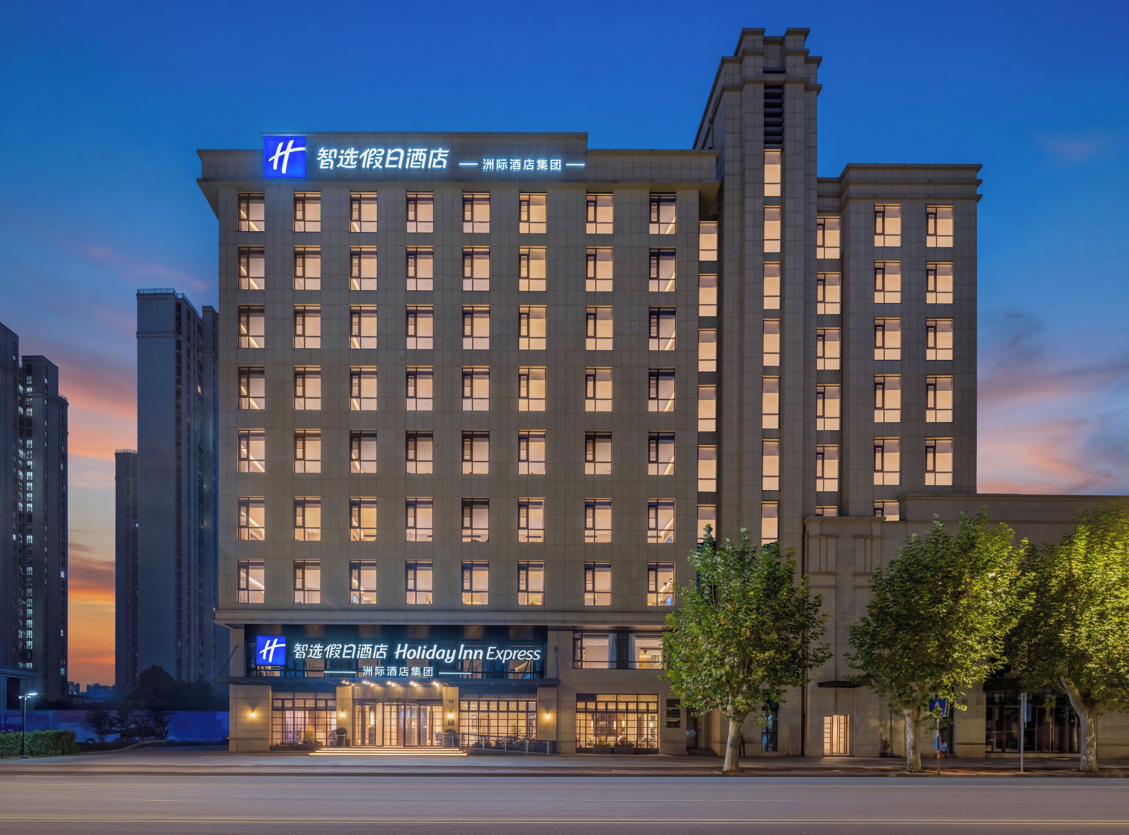 Un hotel de varios pisos con un letrero destacado de Holiday Inn Express, que presenta una fachada moderna con ventanas regularmente distribuidas y una línea de techo plana.