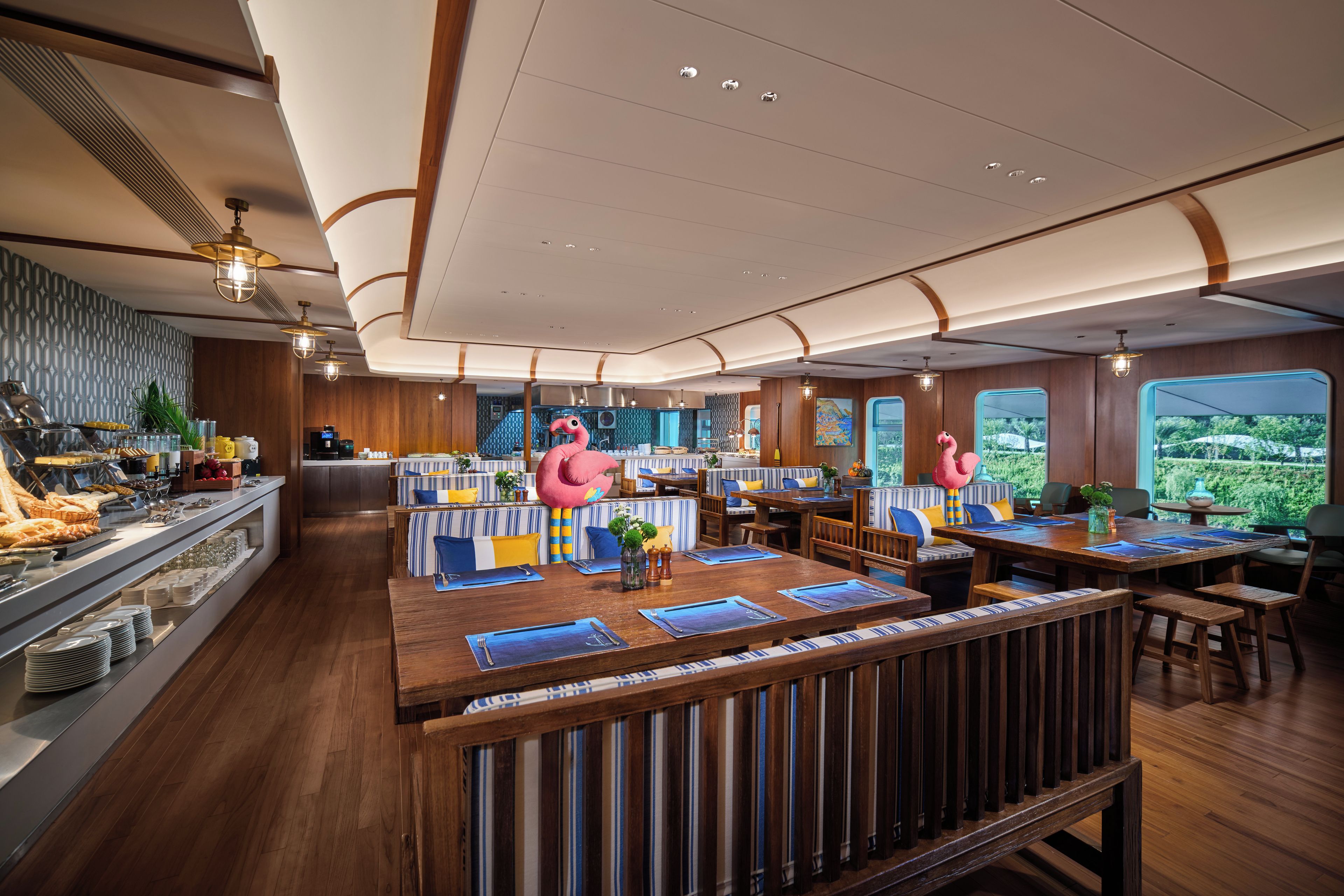 A restaurant with a central bar area, seating arrangements, and a view of the outdoors.