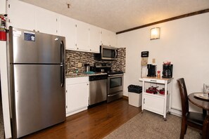A compact kitchen with a refrigerator, microwave, oven, and coffee maker. - ML 329 - Modern, bike-in/bike-out summer retreat! (Snowshoe)