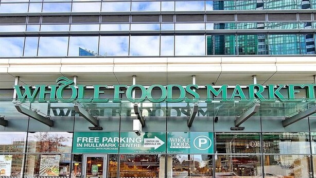 A Whole Foods Market with a sign indicating free parking in Hullmark Centre.