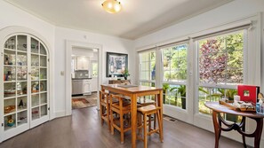 A spacious kitchen with a dining area, large windows, and a view of the outdoors. - Chateau Paso by Avantstay Pool Table + Private Deck Walk to Downtown Paso (Paso Robles)