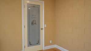 A door with a wine cellar sign, a light switch, and a power outlet on the wall. - 13th Street Retreat by Avantstay Ensuite Suites + Sun Porch & Patio Downtown Paso Robles (Paso Robles)