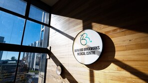 A sign for Burwood Brickworks Medical Centre with a circular design and a logo. - The Foundry by Property Mums (Burwood East)