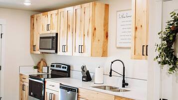 Coffee/tea maker, fridge, cookware/dishes/utensils