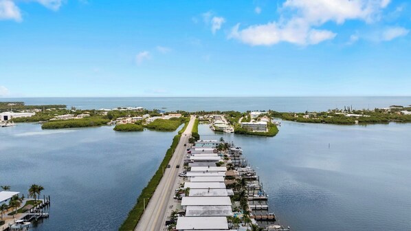 A coastal property with a marina, a road leading to the water, and a clear view of the ocean. - P15 - Waterfront, ground level duplex with Cabana Club (Key Colony Beach)