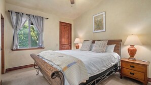 A bedroom with a bed, two bedside tables, a door, a window with curtains, and a wall-mounted lamp. - Vita Amorosa by Avantstay Gated Cottage + Oak & Vineyard Views Near Paso Robles (Atascadero)