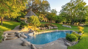 A backyard with a swimming pool, a gazebo, and a waterfall feature. - Oaks and Roses Ranch by Avantstay Pool + Game Room Paso Wine Country (Paso Robles)