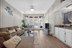 A living room with a sofa, coffee table, and a TV.
