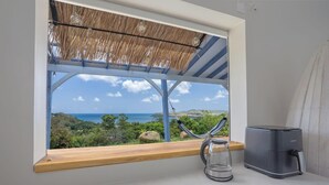A kitchen with a view of the ocean, a hammock, and a coffee maker. - La Villa de Solange - Azur (La Trinité)