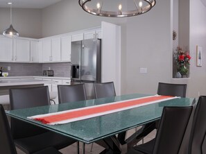 Enjoy meals together at the dining table located beside the kitchen. - Heated Pool | Putting Green | Game Room | Pets OK (Gilbert)