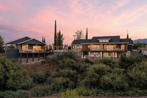 A two-story house with a deck and a covered patio area. - Casa Blanca Old Town Estate + Vineyard View + Pool (Cottonwood)