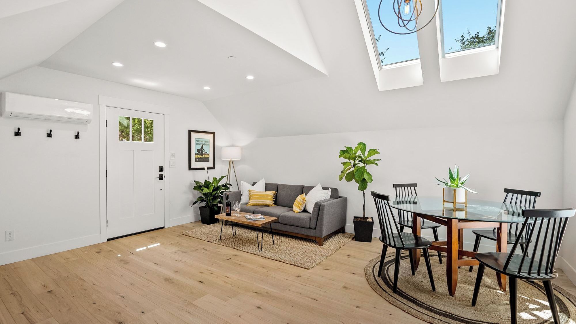 A modern living space with a dining area, a sofa, and a coffee table.