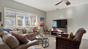 A living room with a sofa, coffee table, TV stand, and a chair. - Tranquility by Avantstay Spa + Firepit + BBQ Minutes to Downtown Paso Robles (Paso Robles)