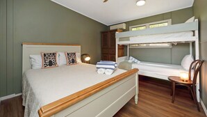 A bedroom with a single bed, a bunk bed, a wooden headboard, a ceiling fan, and a bedside table with a lamp. - AMAROO ARCADIA – GABUL WAY (Arcadia)