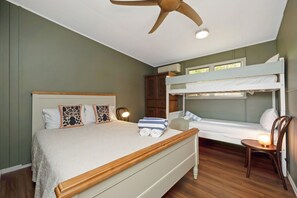 A bedroom with a single bed, a bunk bed, a wooden headboard, a ceiling fan, and a bedside table with a lamp. - AMAROO ARCADIA – GABUL WAY (Arcadia)