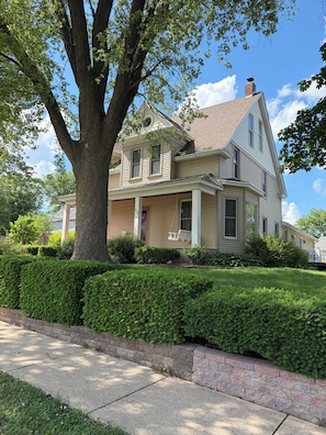 A two-story house with a large tree in the front yard. - Gorgeous 4-bedroom house in charming Dodgeville. (Dodgeville)