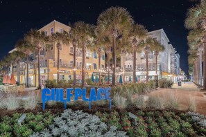 A hotel named 'GULF PLACE' with multiple floors, palm trees, and outdoor seating areas. - Amazing Rooftop Views | 2 Min Walk to Beach (Santa Rosa Beach)