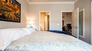 Ein Hotelzimmer mit einem Bett, einem Bild an der Wand und einem Fernseher in der Ecke.