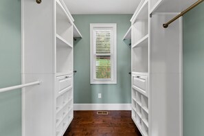 A narrow hallway with white shelving units on either side, a window with blinds, and a wooden floor. - Heavenly Haven - Lake Nottely | Double Decker Dock | Firepit (Blairsville)