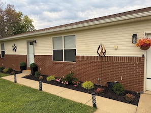 A two-story building with a brick facade, a front door, and a small window with shutters. - Modern 2-bedroom house in Beautiful Mount Vernon, Ohio (Mount Vernon)