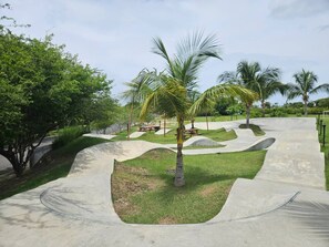 A concrete skate park with curved ramps and a palm tree in the center. - Beachfront Apartment, Family-Friendly Atmosphere, Just a Few Steps from the Ocean. (San Carlos)