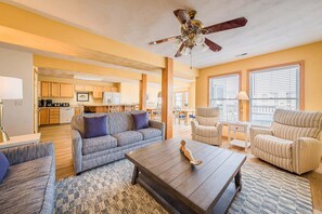 A spacious living area with a sofa, armchairs, a coffee table, and a ceiling fan. - Captains Choice-KDH MP 7, Oceanside, Pool, Hot Tub, Pets OK, YR Flex Stays (Kill Devil Hills)